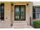 Close up of the home's double door entryway and brick facade with black shutters and trim at 2785 Old Sewell Rd, Marietta, GA 30068