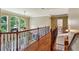 Elegant hallway with hardwood floors, iron railing, and a view of the staircase at 2785 Old Sewell Rd, Marietta, GA 30068
