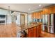 Kitchen island with granite countertops, stainless steel appliances, and a view of the living room and fireplace at 2785 Old Sewell Rd, Marietta, GA 30068