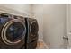 Laundry room featuring front load washer and dryer units with tile flooring at 2785 Old Sewell Rd, Marietta, GA 30068