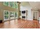 Spacious living room with hardwood floors, large windows, a fireplace, and built-in shelving at 2785 Old Sewell Rd, Marietta, GA 30068