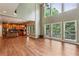 Bright open-concept living room and kitchen with hardwood floors, vaulted ceilings, and large windows at 2785 Old Sewell Rd, Marietta, GA 30068