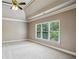Spacious main bedroom with a tray ceiling, ceiling fan and natural light at 2785 Old Sewell Rd, Marietta, GA 30068