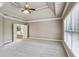 Bright main bedroom with tray ceiling, ceiling fan, access to main bath and an abundance of natural light at 2785 Old Sewell Rd, Marietta, GA 30068