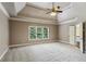 Expansive main bedroom with tray ceiling, a ceiling fan, and a large window at 2785 Old Sewell Rd, Marietta, GA 30068