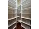 Pantry featuring rows of white shelving and wire storage baskets on dark hardwood flooring at 2785 Old Sewell Rd, Marietta, GA 30068