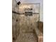 Modern walk-in shower with tiled walls, a built-in seat, and sleek glass door at 2785 Old Sewell Rd, Marietta, GA 30068