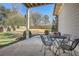 Outdoor patio area featuring metal table and chairs in a fenced backyard with mature trees and manicured landscaping at 2987 Jefferson St, Atlanta, GA 30341