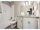 Bathroom features a tiled shower-tub, decorative lighting, and vanity with granite countertop at 2987 Jefferson St, Atlanta, GA 30341