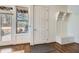 Cozy mudroom entrance area features a bench with storage and coat hooks near a window and door to the backyard at 2987 Jefferson St, Atlanta, GA 30341