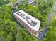 Aerial shot of a red brick building in a wooded area with parking at 319 Atlanta Se St # 315, Marietta, GA 30060