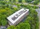 Stunning aerial view of a brick building surrounded by lush greenery near a road and train tracks at 319 Atlanta Se St # 315, Marietta, GA 30060