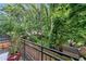 Secluded backyard view from the balcony with green foliage and trees offering privacy and shade at 319 Atlanta Se St # 315, Marietta, GA 30060