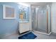 Bathroom features a blue accent wall, white vanity and glass shower at 319 Atlanta Se St # 315, Marietta, GA 30060