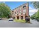 Angle view of the red brick condo building with arched windows and street parking at 319 Atlanta Se St # 315, Marietta, GA 30060