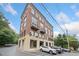 Exterior view of the red brick condo building with street parking at 319 Atlanta Se St # 315, Marietta, GA 30060