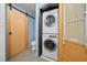 Efficient laundry area with stacked washer and dryer, modern sliding door, and tiled floor at 319 Atlanta Se St # 315, Marietta, GA 30060