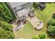 Aerial view of backyard showing an outdoor kitchen, hot tub, and fire pit for relaxing and entertaining outdoors at 3750 Sweeting St, Cumming, GA 30041