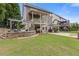Beautiful backyard featuring an outdoor kitchen with a grill, a hot tub, and covered patio for entertaining at 3750 Sweeting St, Cumming, GA 30041