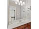 Half-bathroom featuring a white countertop, wood cabinets, and framed art at 3750 Sweeting St, Cumming, GA 30041