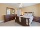 Bedroom with dark wood furniture, neutral walls, and plush carpeting at 3750 Sweeting St, Cumming, GA 30041