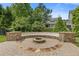 Stone fire pit with built in seating offers a cozy and inviting space for outdoor gatherings and relaxing evenings at 3750 Sweeting St, Cumming, GA 30041