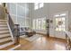Bright foyer showcasing hardwood floors, staircase, and a large window with stylish window shutters at 3750 Sweeting St, Cumming, GA 30041
