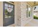 Close up of the front door and brick exterior with a custom wreath accenting the welcoming entrance at 3750 Sweeting St, Cumming, GA 30041