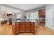 Open-concept living space showcasing a kitchen island and living room with custom built-ins and a fireplace at 3750 Sweeting St, Cumming, GA 30041