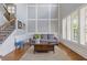 Bright living room showcasing hardwood floors, staircase, and a large window with stylish window shutters at 3750 Sweeting St, Cumming, GA 30041