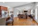 Open-concept living space with a kitchen island overlooking the living room with a fireplace and custom built-ins at 3750 Sweeting St, Cumming, GA 30041
