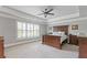 Main bedroom with tray ceilings, neutral carpet, and shuttered windows at 3750 Sweeting St, Cumming, GA 30041