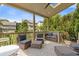 Relaxing covered patio with outdoor seating, wooded views, and a ceiling fan at 3750 Sweeting St, Cumming, GA 30041