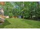 Lush backyard with mature trees offering privacy and a shed perfect for storage, great for outdoor relaxation at 500 Read Ln, Atlanta, GA 30328