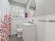 Cozy bathroom features a single sink vanity, matching wood-like tile floors, and natural light from the window at 500 Read Ln, Atlanta, GA 30328