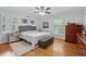 Cozy bedroom with a ceiling fan, hardwood floors, natural light, and neutral decor at 500 Read Ln, Atlanta, GA 30328