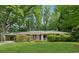 Charming single-story home with a well-manicured lawn, mature trees, and a convenient covered parking area at 500 Read Ln, Atlanta, GA 30328