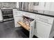 Kitchen island features white cabinetry, sleek hardware, dark countertops and a pull-out shelf at 500 Read Ln, Atlanta, GA 30328