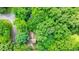 Aerial view of the home surrounded by lush greenery, showcasing the property's private setting at 588 Benson Hurst Sw Dr, Mableton, GA 30126