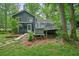 Rear exterior view of the home featuring a hot tub and expansive back deck at 588 Benson Hurst Sw Dr, Mableton, GA 30126