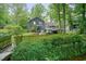 Home's back exterior featuring a spacious deck and lush greenery at 588 Benson Hurst Sw Dr, Mableton, GA 30126