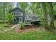 Back of the house featuring a hot tub and multiple tiered decks with landscaped yard at 588 Benson Hurst Sw Dr, Mableton, GA 30126
