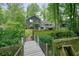 Inviting backyard featuring a charming creek, lush greenery, and a deck, ideal for relaxation and entertaining at 588 Benson Hurst Sw Dr, Mableton, GA 30126
