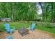 Cozy backyard patio featuring a fire pit and seating, surrounded by a beautifully landscaped yard at 588 Benson Hurst Sw Dr, Mableton, GA 30126