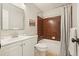 Traditional bathroom featuring a vanity and shower-tub combo with brown tiles at 588 Benson Hurst Sw Dr, Mableton, GA 30126