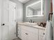 Bright bathroom featuring gray walls, a modern vessel sink, LED mirror and white cabinets at 588 Benson Hurst Sw Dr, Mableton, GA 30126