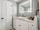 Modern bathroom vanity with granite countertops and white cabinets at 588 Benson Hurst Sw Dr, Mableton, GA 30126