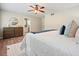 Bright bedroom featuring hardwood floors and a dresser, with the bathroom door visible at 588 Benson Hurst Sw Dr, Mableton, GA 30126