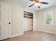 Cozy bedroom with hardwood floor and a closet with shelves for storage at 588 Benson Hurst Sw Dr, Mableton, GA 30126