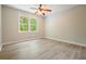 Bedroom with ceiling fan, neutral paint, wood-look flooring, and sun-filled window at 588 Benson Hurst Sw Dr, Mableton, GA 30126